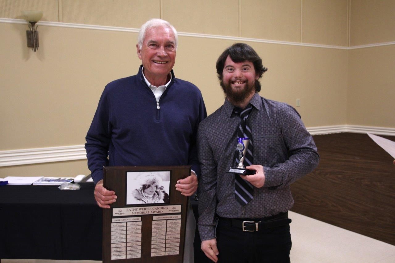 Gord Canning presenting the Kathy Canning Award  for the most improved male athlete of the season to Kevin Lachance at the recent Team banquet.